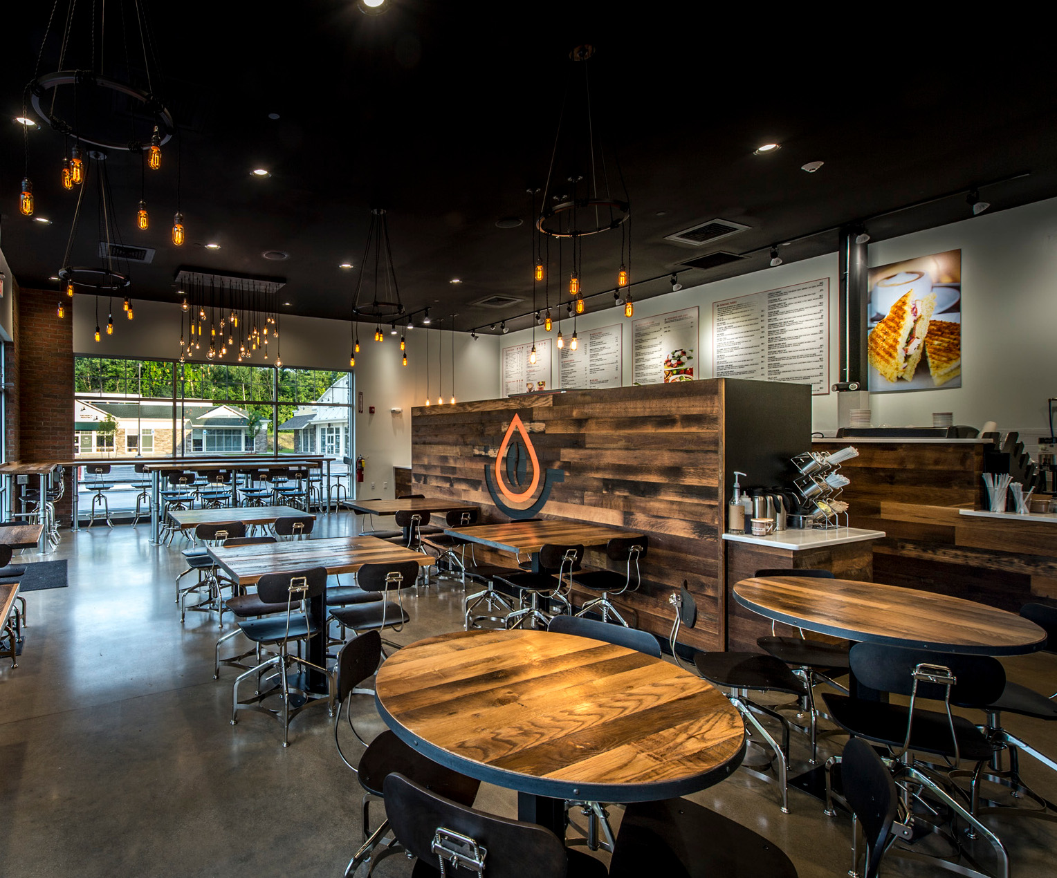 For a new coffee shop, Settlers’ Plank Oak was milled out in the shape of the logo and then colors were hand-painted before the planks received their final coats of finish to match the surrounding walls.