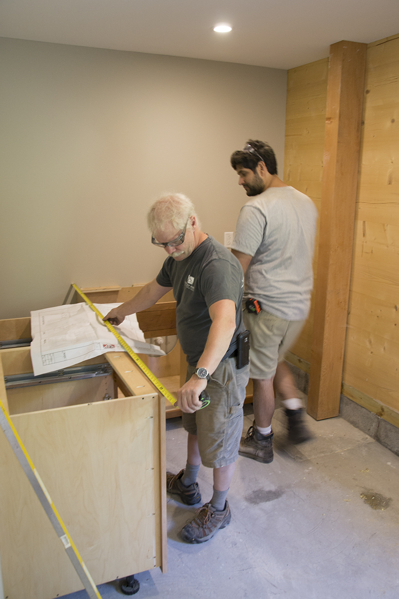Charlie & Tony work on installing the cabinetry in the break room of the new shop.