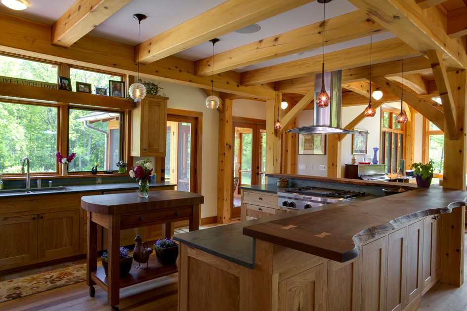 Live edges, butterfly joinery, slate tops, an additional rolling butcher block, and ample counter surfaces afford a growing family space for everyone to participate in kitchen activities.