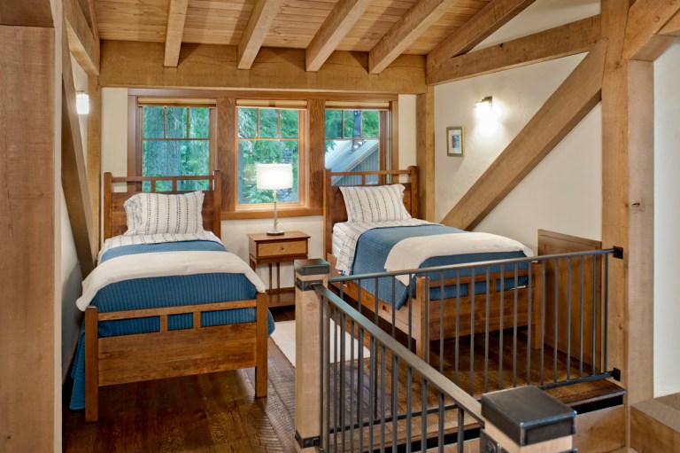 While modest in scale, the upper-level loft offers extra bunk space (above) for family and guests as well as a small gathering space away from the larger common areas (below). Photo (c) Loren Nelson Photography.