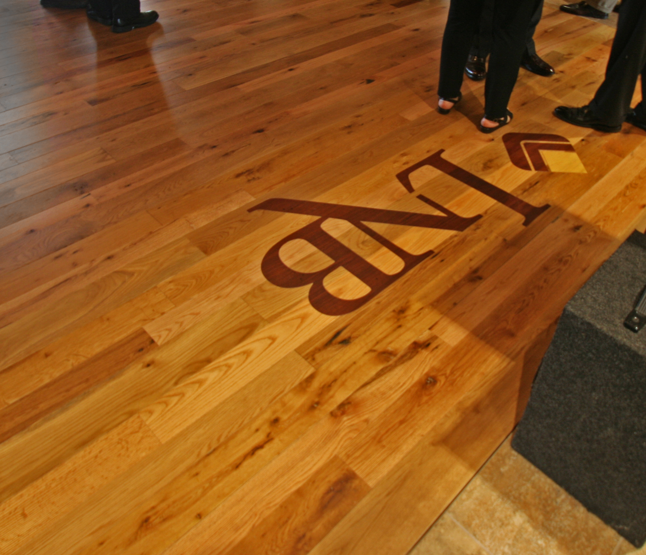 Lyons National Bank custom inlay machined from two reclaimed wood species blends seamlessly with the reclaimed American Gothic Oak flooring.