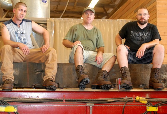 TJ, Cal, and Dave, from our sister company, model the new ‘Rip Saw’ from Timberland. Appropriately enough, that timber they’re sitting on is on the deck of Pioneer’s rip saw.