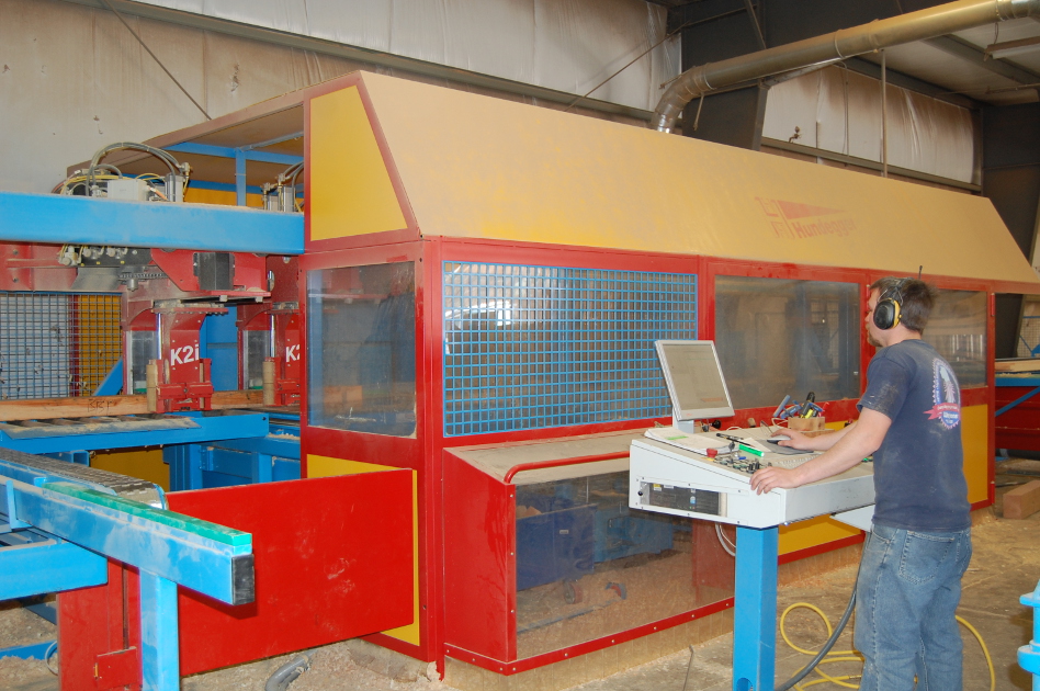 Andy operates the Hundegger controls and computer as a timber is processed.