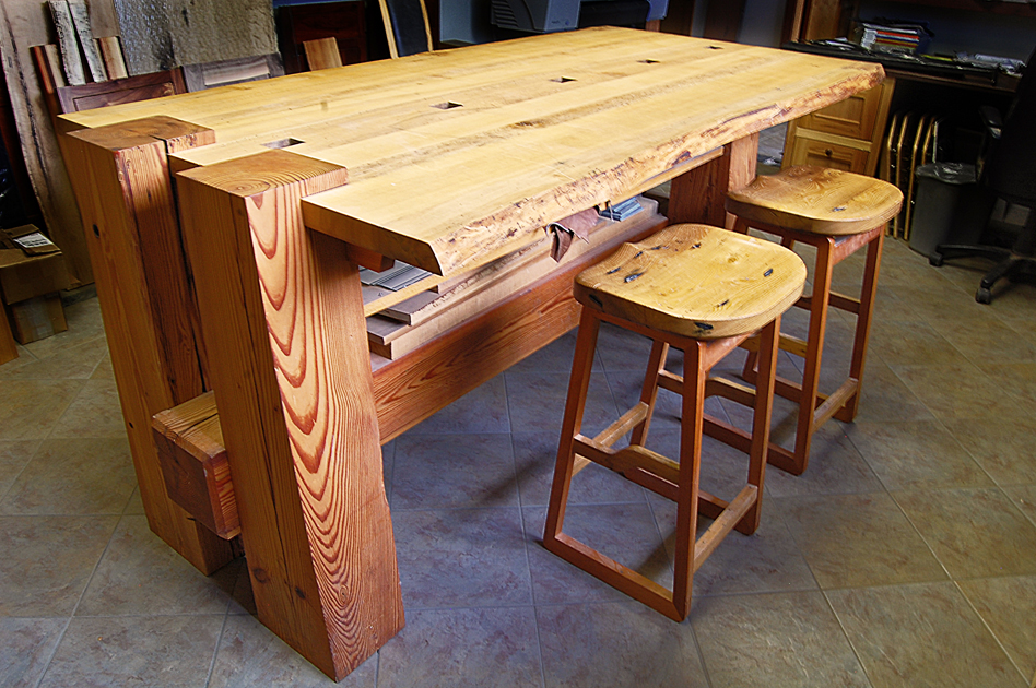 A well-loved ‘timber’ table in the NEWwoodworks showroom celebrates live edges and original mortise pockets in its top, all suspended from heavy Douglas fir timber legs.