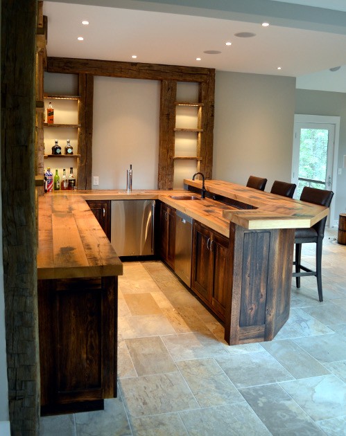 A bar island crafted from reclaimed wood – tops and cabinetry – with shelving from agricultural salvaged timbers.