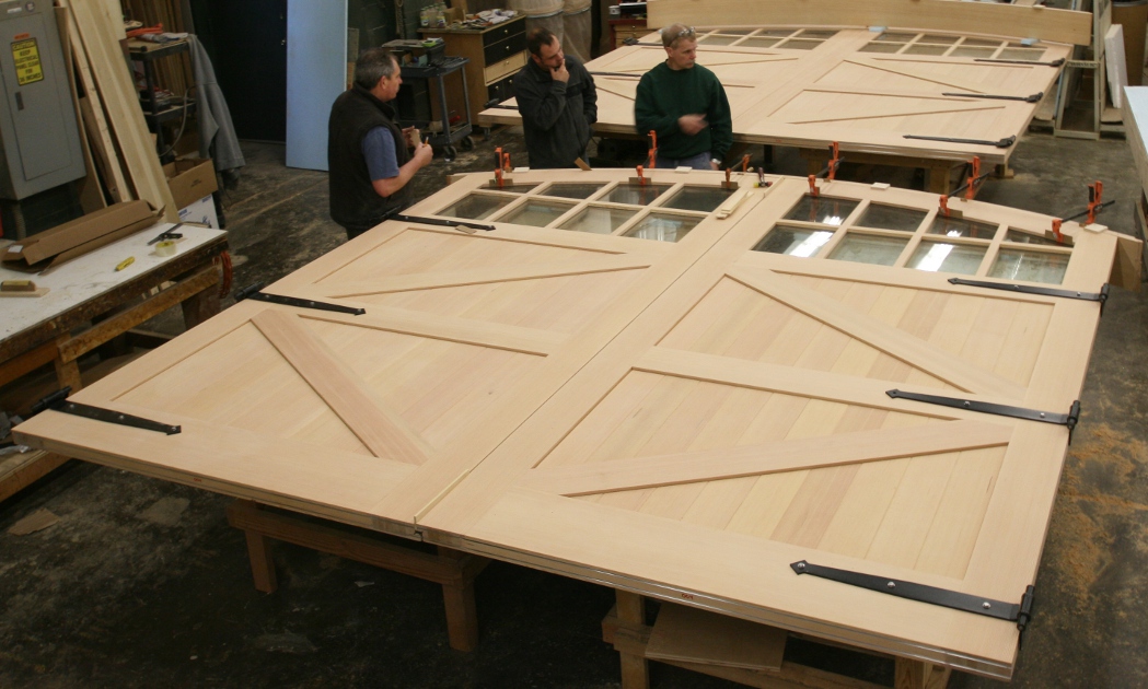 These large barn doors were segmented with mid-rails and crafted using an inner torsion box wrapped with heavy wood wear layers.