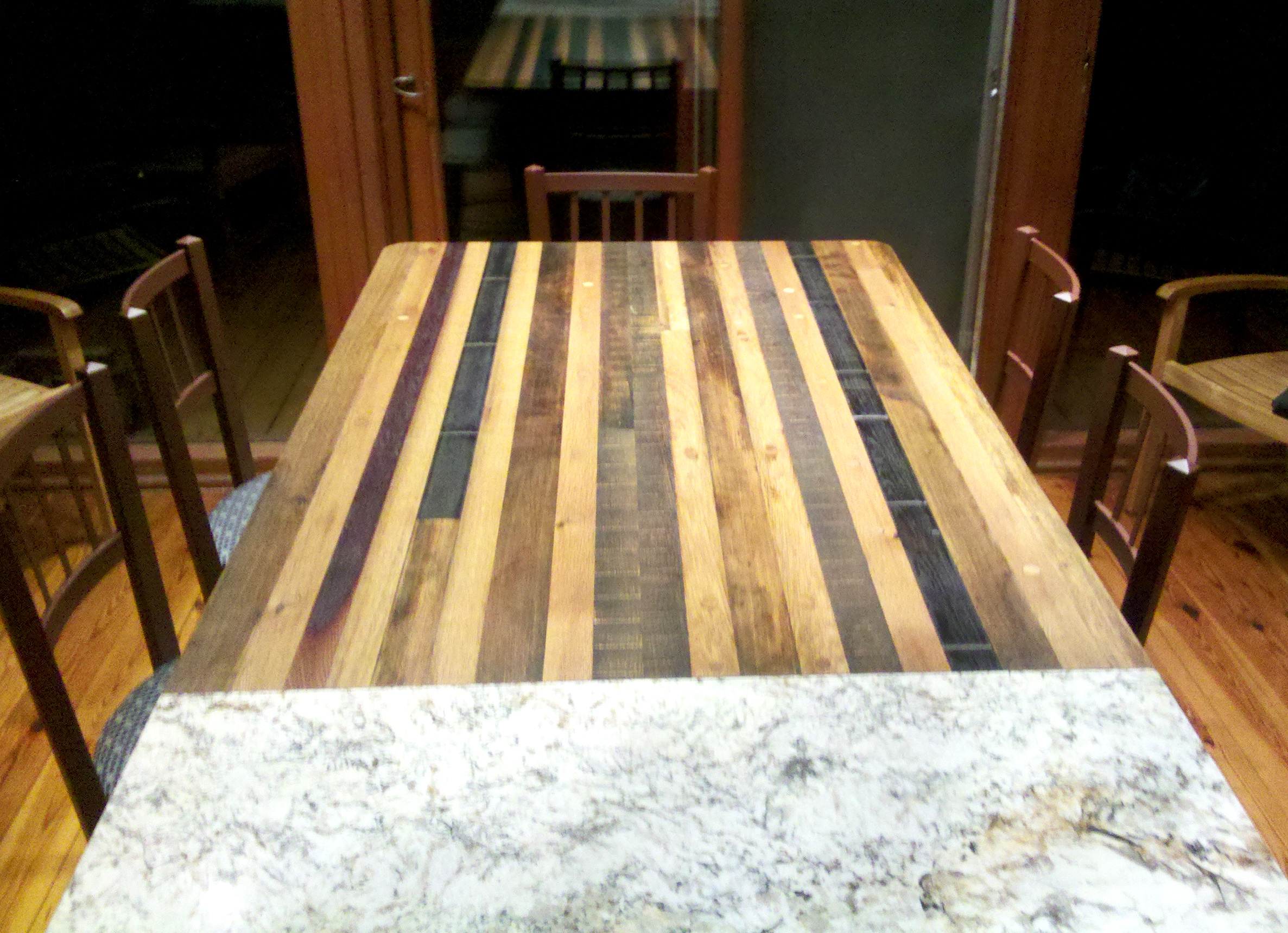 Old French white oak and domestic barrel/vat staves were repurposed into a pier table off the kitchen island, ideally situated for family meals.
