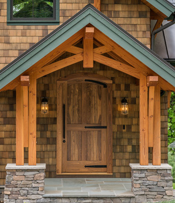 At 9′ tall and several inches thick, this custom walnut entry door with strap hindges opens and closes with ease.