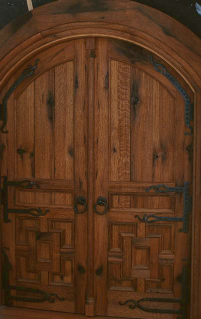These reclaimed oak doors are both arched and curved to match the walls of a circular zen center.