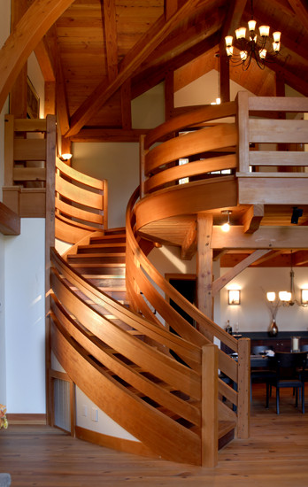 This custom staircase curves and tapers as it reaches the second level. Calculations in CAD, a small scale model, and decades of woodworking experience brought this masterpiece to life. (Crafted of reclaimed Douglas fir and industrial salvaged Jarrah.)