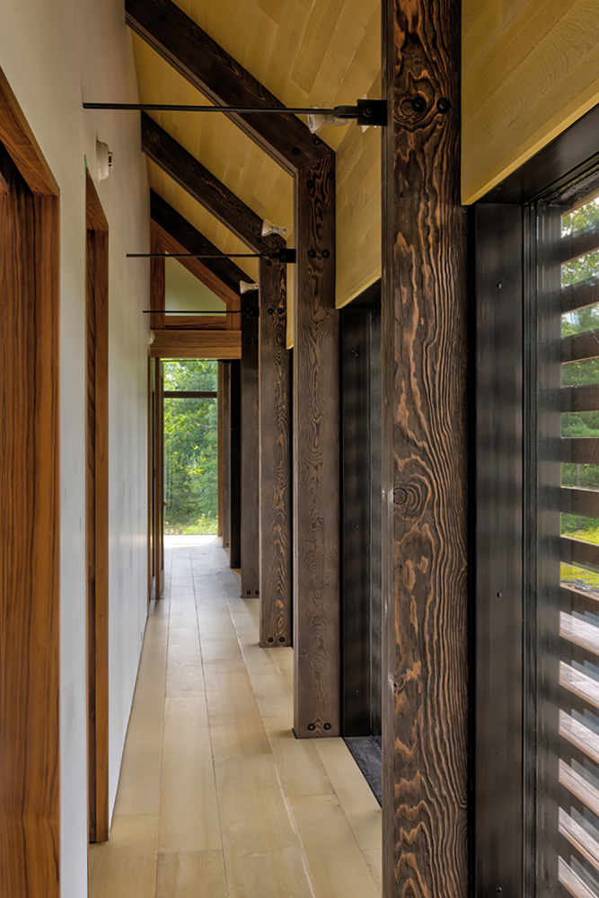 A multi-step finish gave a dark tone with highlighted grain patterns on the solid Douglas fir timbers crafted for this Hudson Valley NY project. Photo by Chris Kendall Photography.