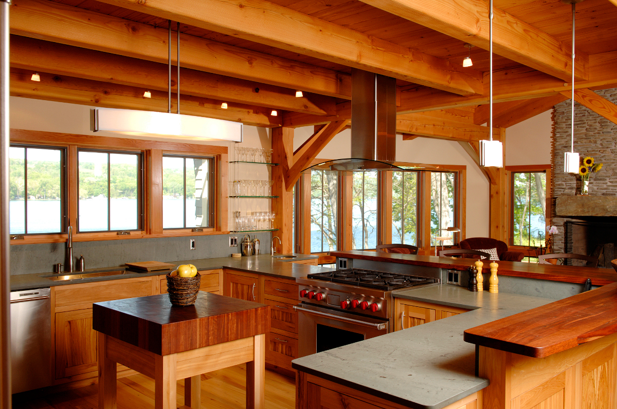 Pioneer Millworks reclaimed wood was thoughtfully crafted by NEWwoodworks into the cabinetry, rolling chop-block, high top, and flooring within the cottage’s kitchen. Photo by Matt Wittmeyer.