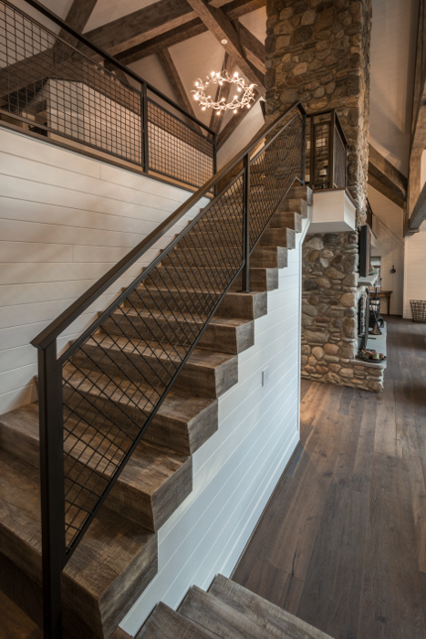 Minimalist metal railing offsets heavy timber treads, customized by NEWwoodworks to match the timber frame tone/texture.