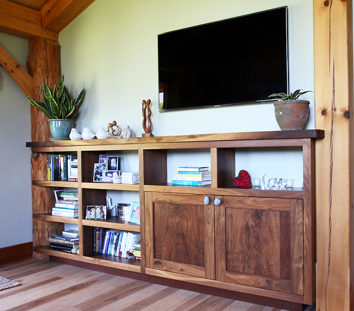 This built-in combines open shelving scribed around a corner post with cabinets and a live-edge top.