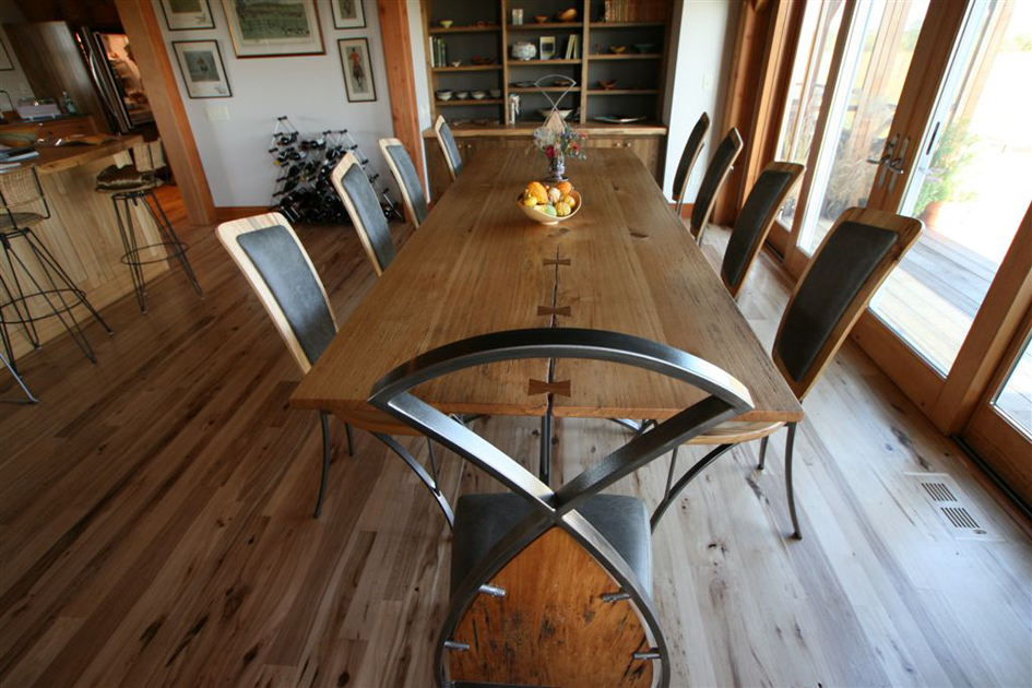 In this New York home, two wide reclaimed Elm thresher boards were bookended, butterfly joined, and placed atop a custom fabricated metal base.