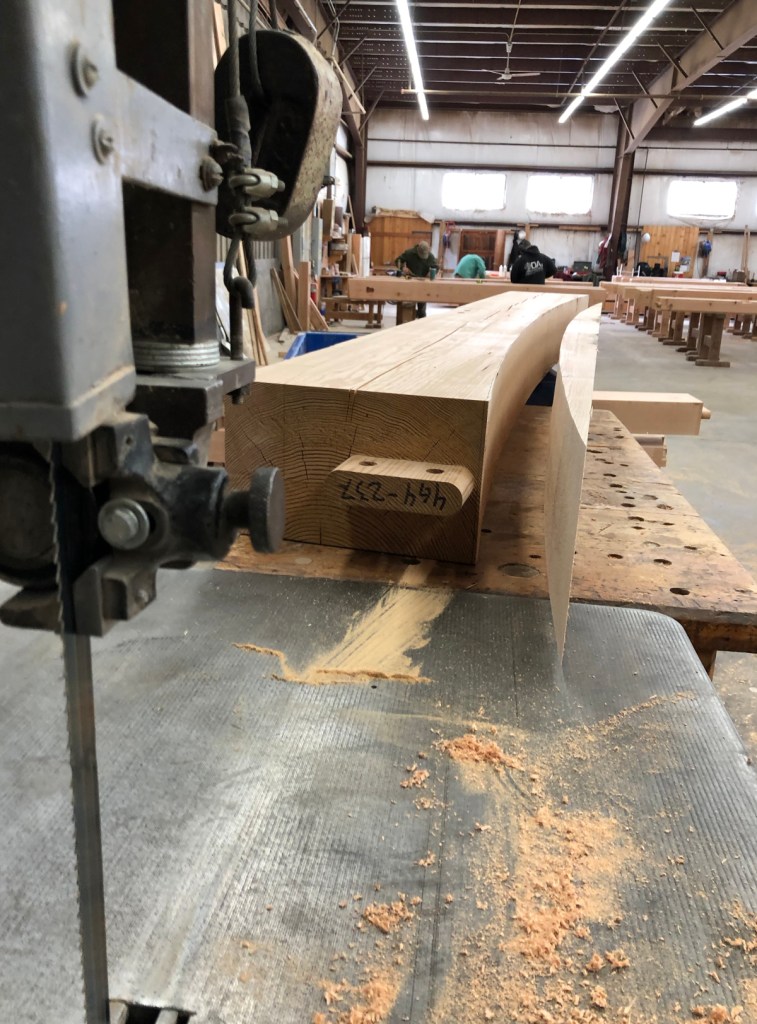 Each bottom cord for the LNB bank frame has a gentle curve cut on the large band saw in our timber frame shop. (10″ is about the biggest timber we’ll put through this saw.)