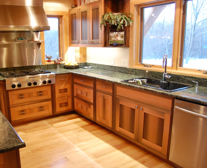 Tim and Laurie’s kitchen cabinetry was crafted from Douglas fir timbers that spent a century underwater as a canal lock. The wood carries signs of its previous life with mineral staining and tight grain patterns.