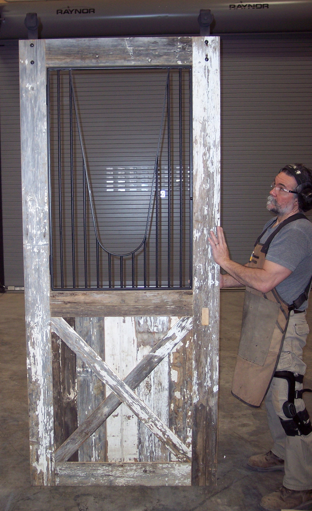 A unique pantry door makes use of reclaimed painted barn siding with a modified stall door guard. (Thanks to Enrique for showcasing this door!)