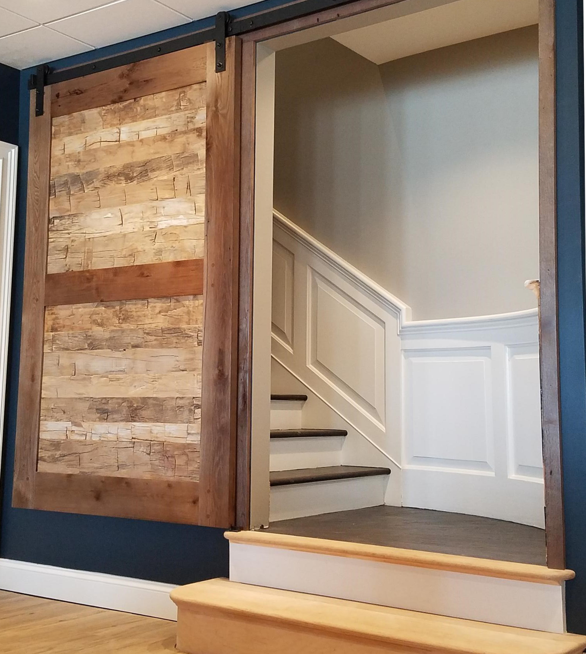 Reclaimed hand hewn timber skins bring texture and character to a lower level rec room entry.
