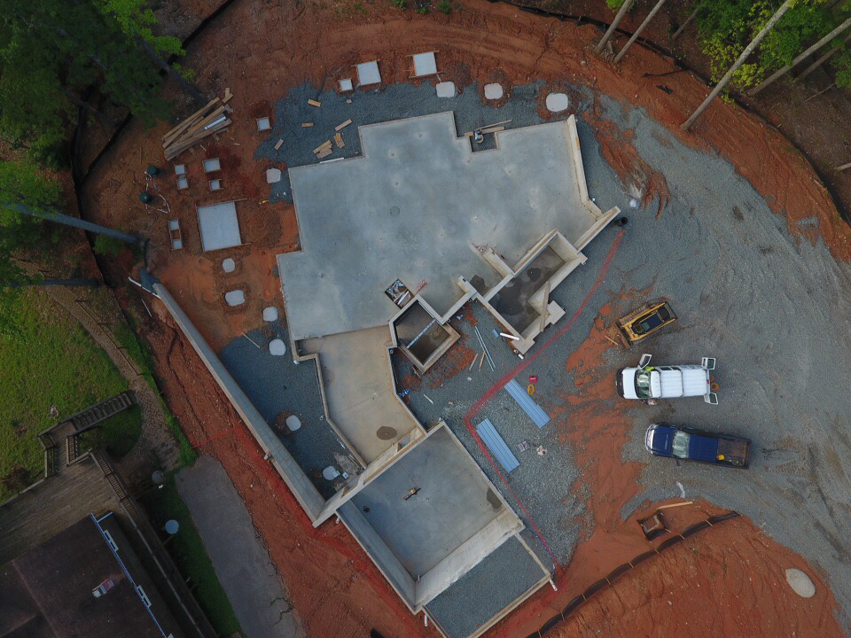 An aerial view of the foundation shows the “kinked” or “L” shaped layout of the home.