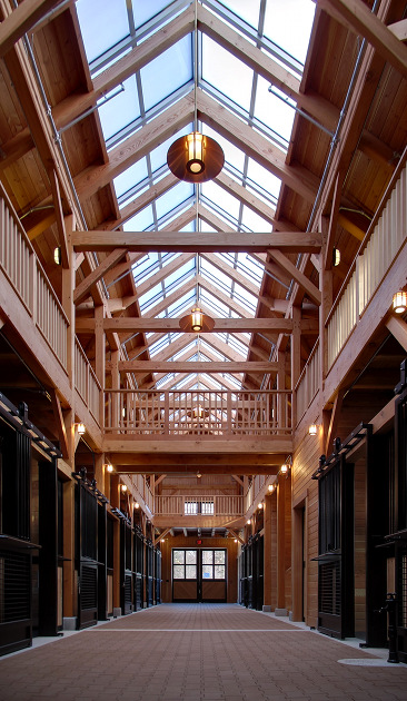 This (amazing!) custom timber frame stable in Massachusetts is nearly ready for equine inhabitants. The open hay loft, clerestory, and large windowed entry doors offer an abundant amount of natural light to the interior spaces. I know my horse would love it here.