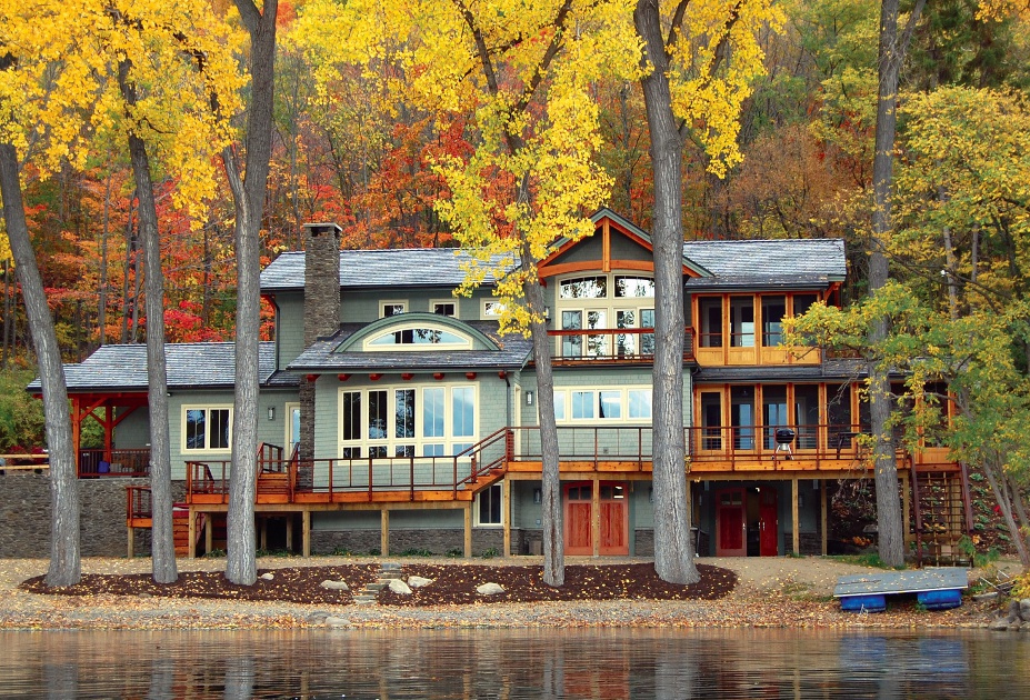 Viewed from the lake, the timber frame cottage opens and expands to accommodate indoor/outdoor living spaces at the main (middle) level and storage on the lower level. Effort was made to preserve the existing mature trees/landscape.