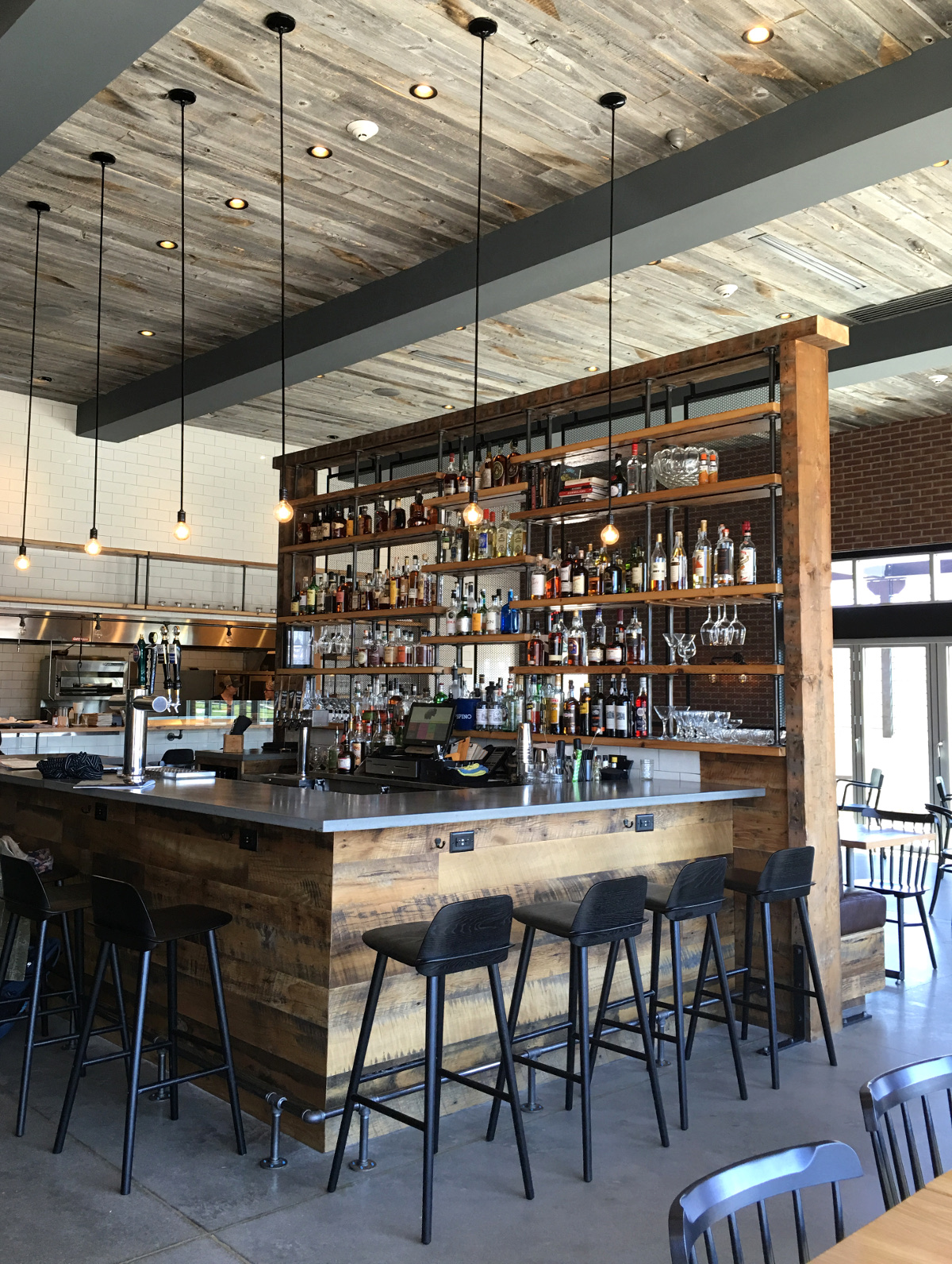Kindred Fare bar from front to shelving was crafted of reclaimed wood by NEWwoodworks.