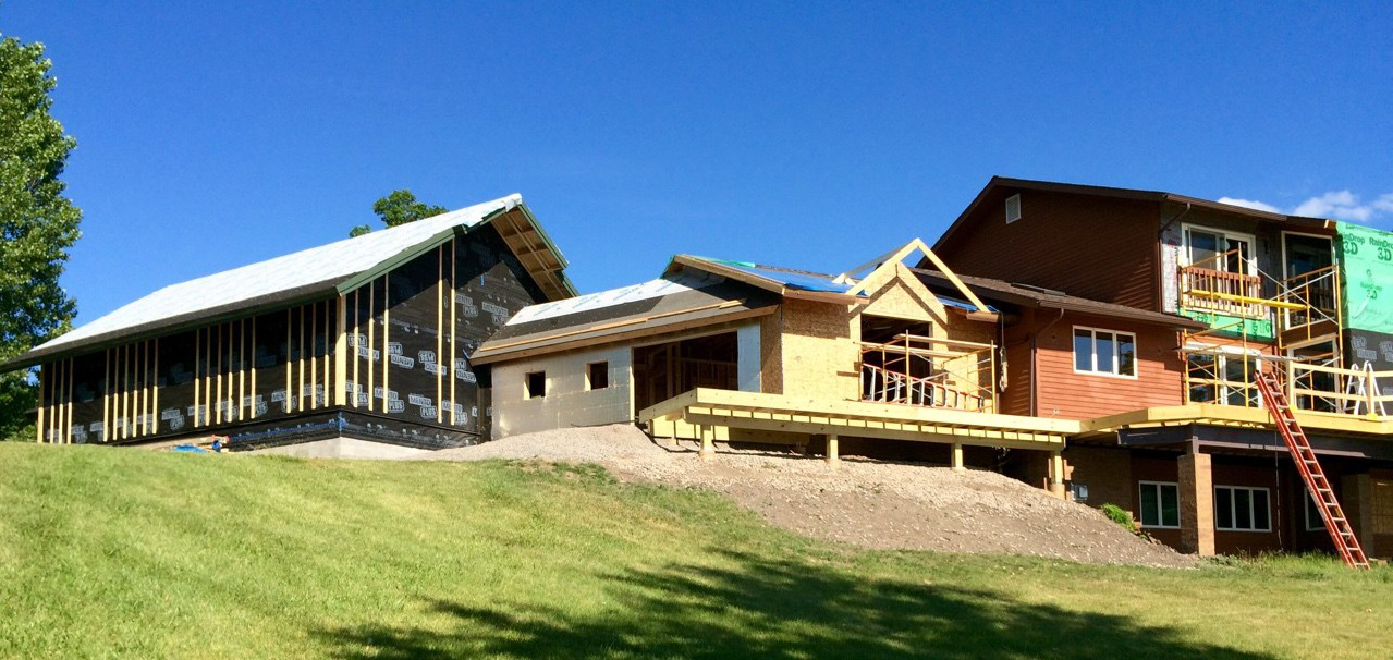 Updating the lakeside facade and a glimpse of the back of the new garage.