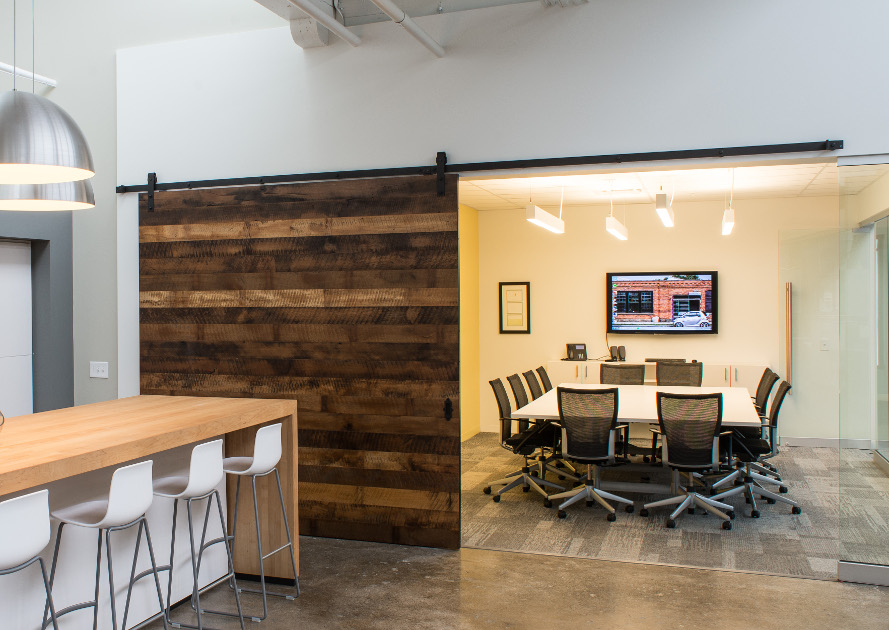 Reclaimed mixed hardwoods were re-worked into a flat track 8’x8′ door for a conference room in Rochester NY.