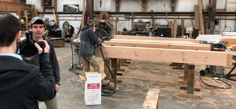 Mike, shop foreman and master timber framer, was at ease on camera, explaining some of the final steps coworkers Zane and Jason were taking with the bank timbers.