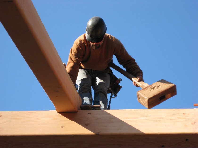 Master timber framer Mike Gullace makes handling the beetle look easy from the ground or on a timber. Notice the angle on the end of the beetle head? Part of crafting a custom beetle is in the details and some feel the angle cut helps achieve better weight distribution when swinging the hammer.