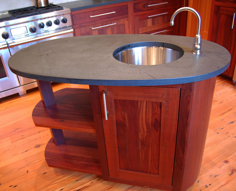 A modest Reclaimed Jarrah wood island with a soap stone top and steel sink provides a bit of additional prep space.