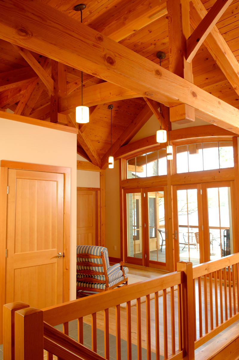 Upon entering from the road, the upper level sitting area and balcony are visible while a central stair encourages visitors to continue forward and down to the main community spaces. Photo by Matt Wittmeyer