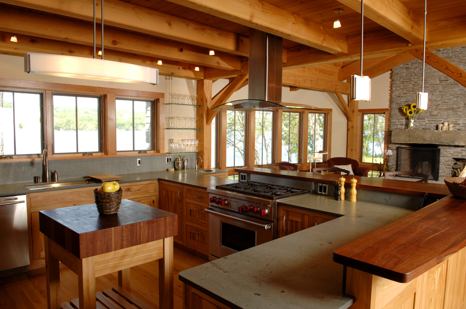 A lake home’s reclaimed beech kitchen affords panoramic views of the water and abundant space for entertaining. Photo by Matt Wittmeyer.