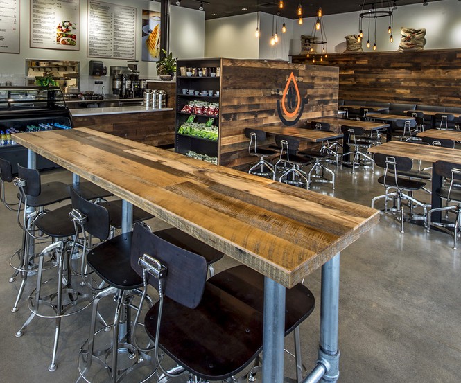 Pressed Cafe incorporated reclaimed hardwoods with original surfaces and a CNC logo from the NEWwoodworks shop.