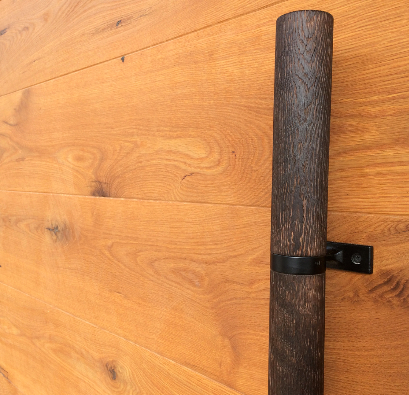 Charlie, one of NEWwoodworks craftsmen turns wood in his spare time. He turned a long oak handle for this reclaimed oak entry door.