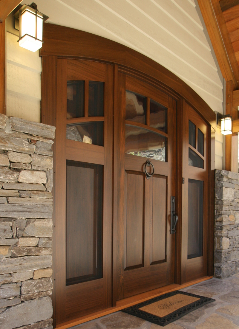 This mountain home’s front door (crafted of reclaimed cypress with a custom finish) has ‘double’ sidelights; the interior set opens to allow airflow through the screened exterior set while ensuring the occasionally adventurous mountain wildlife (bears…) cannot break in.