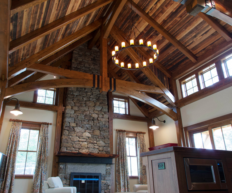 Reclaimed timbers and reclaimed mixed softwoods as ceiling t&g add great color (patina) and storied history to this New England home. To me, this project is perfectly topped off with hand hammered metal strapping on the trusses.