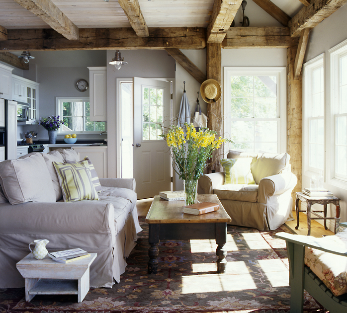 Our timber framers were careful to maintain the original hand hewn surface, mortise pockets, and peg holes in reclaimed agricultural timbers, sourced by Pioneer Millworks, for this modest cottage.