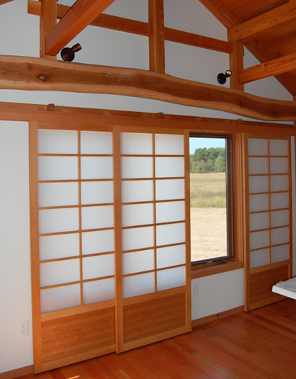 A plethora of styles and aesthetics can be met with flat track doors. Here shoji-inspired paper screen flat track doors provide privacy and ambiance in a master bedroom.