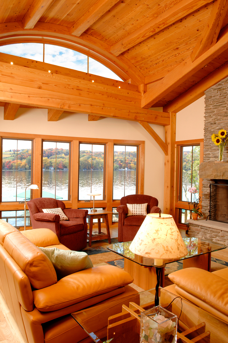 Reclaimed Knotty’n’Naily t&g celebrates its character throughout this lake cottage, including over the timber frame eyebrow dormer window and family room. Photo by Matt Wittmeyer.
