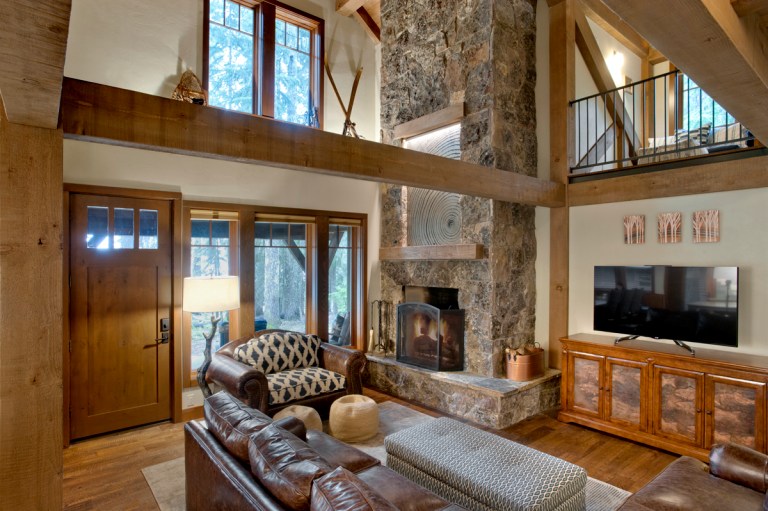 The modest size great room is open to the ridge and loft areas overhead creating a bigger feel to the overall space. Photo (c) Loren Nelson Photography