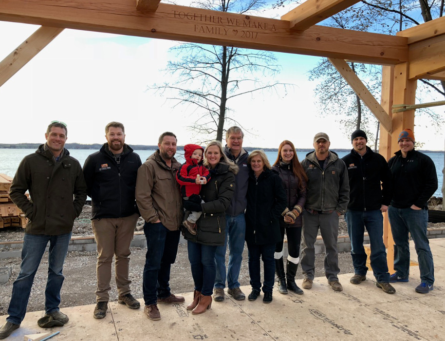 A few members of our design, construction, and engineering teams joined Jim, Tina, and their daughter/son-in-law/grandson for a quick photo at the end of the first raising day.