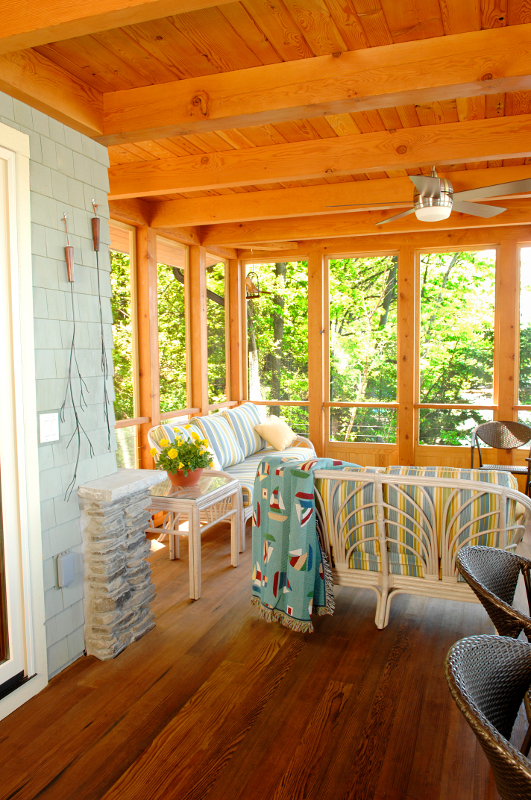 A custom timber frame screened porch is a major gathering space for family and friends enjoying the lake cottage. Photo by Matt Wittmeyer.