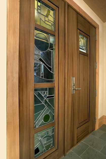 The entry door of Jonathan and Maxine’s Portland, Oregon home combined antique ‘sinker’ cypress with stained glass crafted by artisan Jennifer Kaplan. (Photo: Loren Nelson Photography)