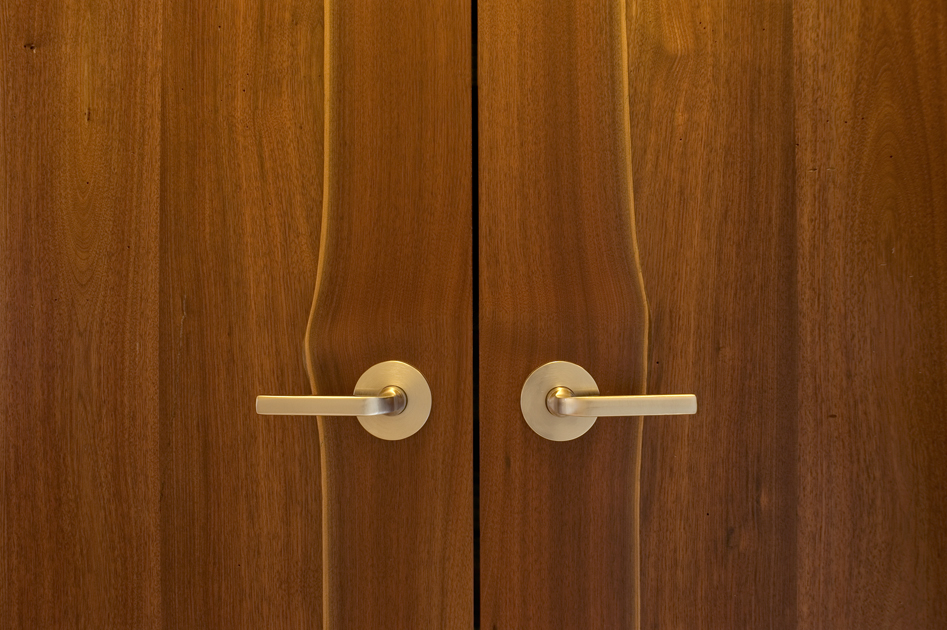 Live edge walnut planks were kept intact for a double interior door set.