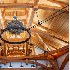 This 36’ x 36’ great room is characterized by its “circle in a square” timber frame: diverse geometry accomplished with a combination of solid, glulam, and grain-matched curved timbers
