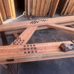 A close-up at the hardware assembly of a truss from the New Energy Works NEWBeamery. Glulam beams can facilitate a variety of joinery techniques, just like traditional timber.