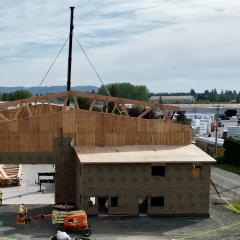 A truss is put into place by crane at the NEWBeamery production facility.